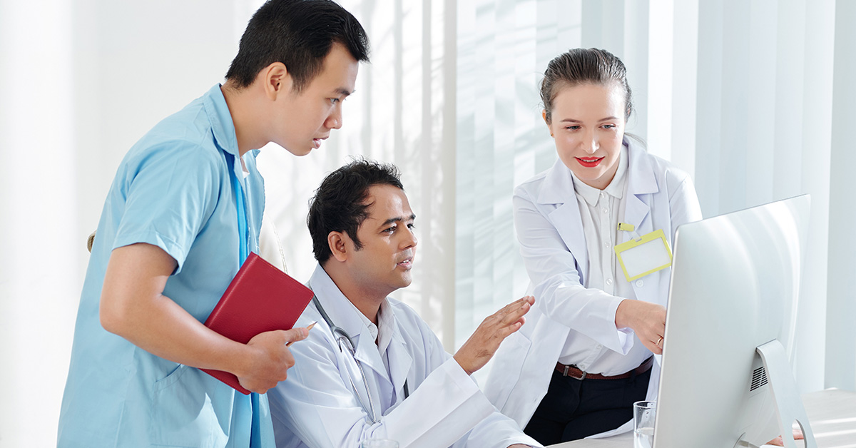 Doctors discussing results on a computer
