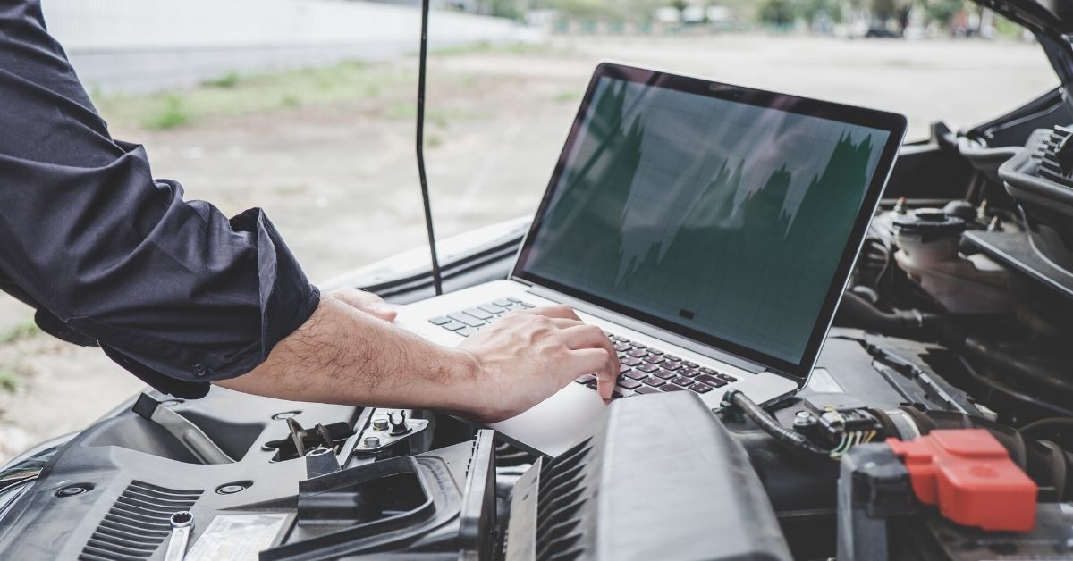 Man searching for car parts on laptop