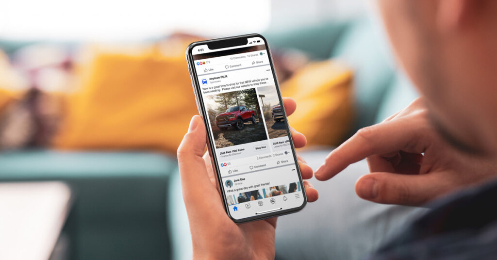 191125.1_-_Facebook_Instagram_Ads_Dealer_Teamwork_FCA_LIFESTYLE_1200x628 person looking at a cdjr facebook ad on a phone