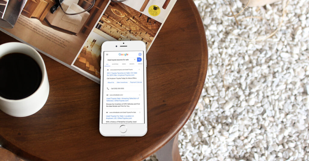 200717.1_-_Dealer_Teamwork_Used_Vehicle_Marketing_PPC_Mobile_LIFESTYLE_1200x628 Used vehicle paid search ad on a phone
