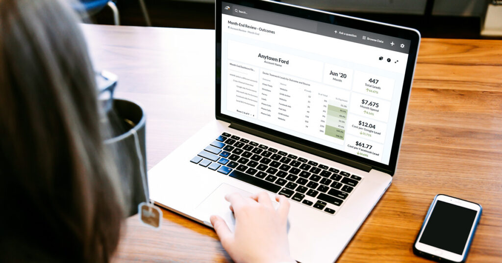 200724.1---Dealer-Teamwork-MPOP-Analytics---LIFESTYLE-mockup-laptop-zoomed-out---OGimage-1200x628 person looking at mpop analytics reports on a laptop