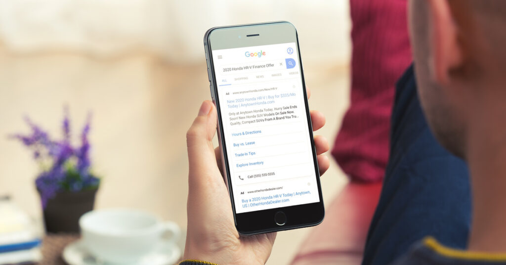 200729.1---Honda-Paid-Search-Ad-Mobile---LIFESTYLE---1200x628 person looking at a honda google ad on phone