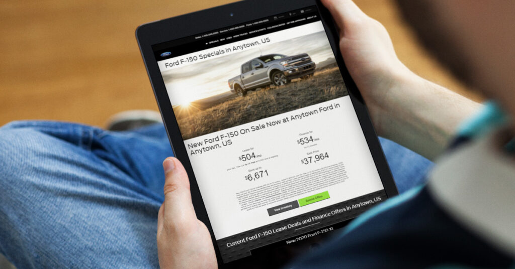 200813.1---Ford-F-150-landing-page-on-tablet---LIFESTYLE---1200x628 person looking at a ford landing page on a tablet