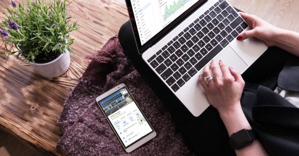 201030.1---Dealer-Teamwork-Hyundai-GMB-Case-Study-Image---1200x628 person looking at GMB results on laptop and GMB profile on a cell phone