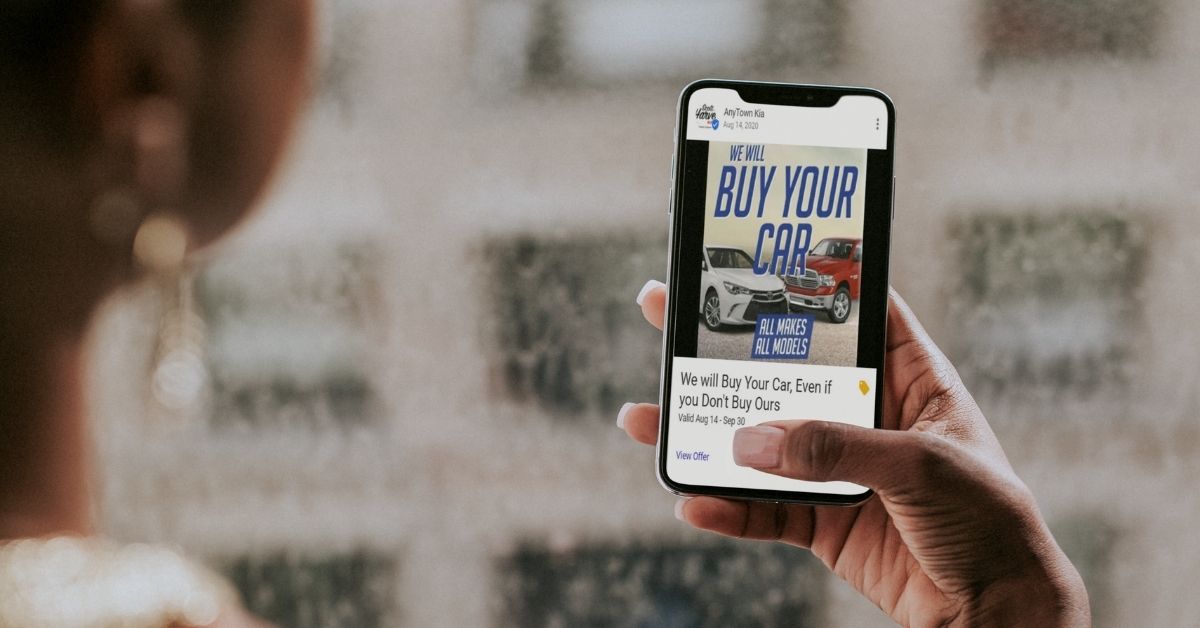 Image of a person holding a phone with a GMB trade-in offer on-screen.